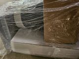 boxes wrapped in plastic sitting on top of each other in a room