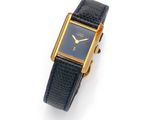 an image of a gold plated wrist watch on a black leather strap