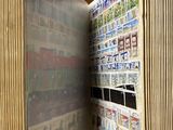 an open book with stamps on it sitting on a table