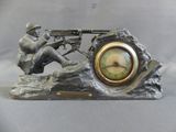 a statue of a man with a machine gun on a rock