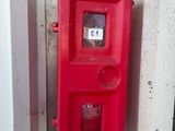 a red fire hydrant on the side of a building