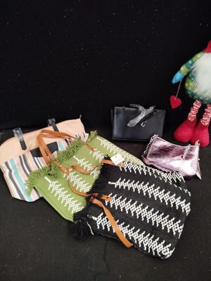a small bag and a small purse on a black surface