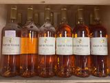 several bottles of wine are lined up in a wooden box