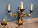 four candles that are sitting on the wall next to each other
