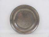 a silver plate on a white surface with a white background