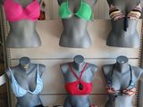 several mannequins are lined up on a shelf in a room