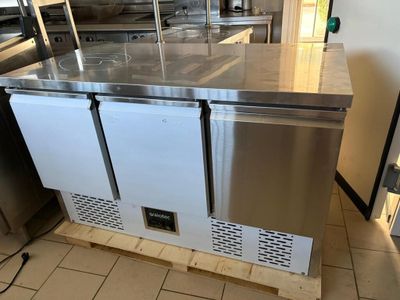 a stainless steel counter top with two freezers on it