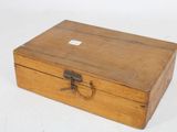 a small wooden box with a handle on a white surface