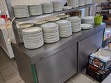 de nombreuses assiettes empilées sur le plan de travail de la cuisine