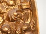 a gold sculpture of a man and a woman in a boat