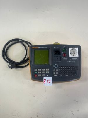 un gros plan d'un téléphone portable posé sur une table, avec un câble