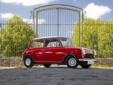 a small red car that is parked in front of a gate