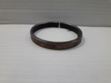 a close up of a wooden ring with a date on it