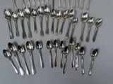 a lot of silver spoons and spoon spoons on the table