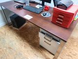 a desk with a computer monitor, keyboard and mouse on it