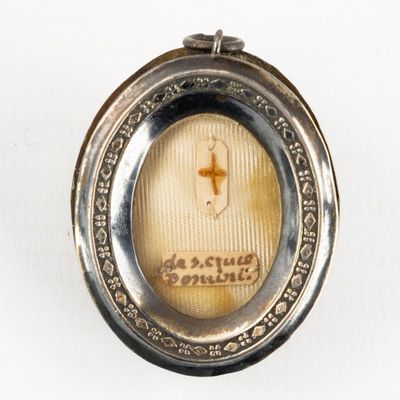 a silver locke with a picture of a cross on it