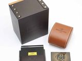 a black box with a brown leather wallet and a brown leather case