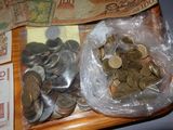 a bag of coins and a bag of money on a table
