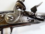 a close up of a gun on a white surface