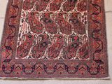 an old rug with a design on it on a white floor