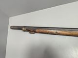 an old wooden rifle mounted on a wall in a room