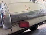 a close up of a white car with bullet holes on it