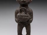 a statue of a man holding a baby in his arms
