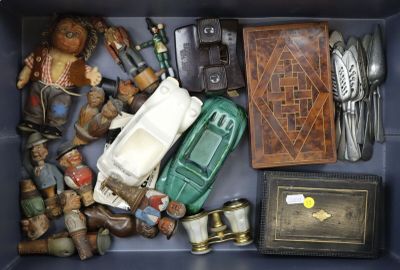 a blue box filled with assorted items including a green car and other items