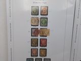 two pages of a book with different stamps on them on a table