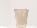 a small glass cup sitting on a white surface