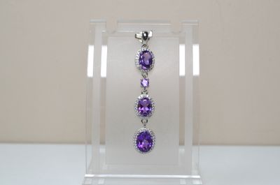 an image of a display case with a pair of earrings on it