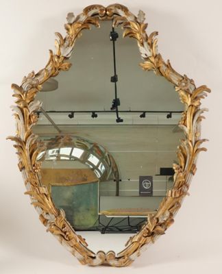 an image of a mirror with a gold frame and a gold leaf design