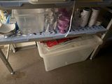 a shelf that has a lot of dishes and cups on it