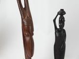 two wooden sculptures of a woman and a man on a white background