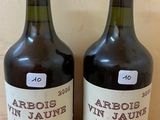 two bottles of wine sitting on top of a wooden table