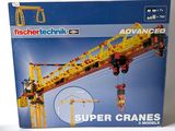 a box of lego technics with a crane on top of it