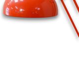 an image of a red desk lamp on a white background