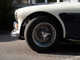 a white and black car parked on the side of the road
