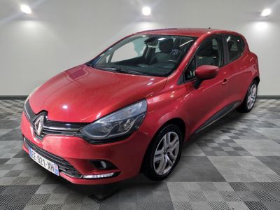 a red car parked in a garage with a checkered floor