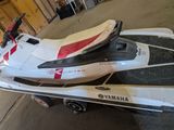a white and red jet ski parked in a garage