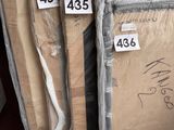 several cardboard boxes are stacked on top of each other in a warehouse