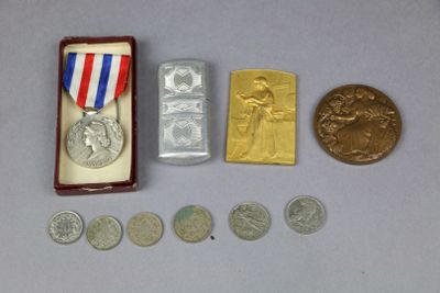 a small box with coins and a medal on it