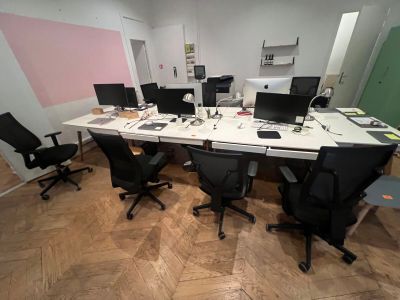 many computers on the desk in this office