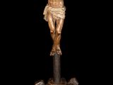 an image of a statue of jesus on the cross on a pile of rocks