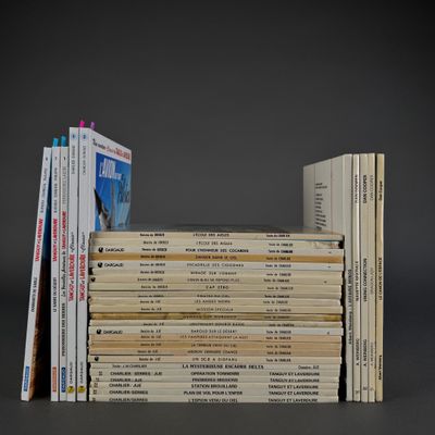 several books stacked on top of each other on a gray surface