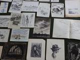 a lot of drawings on the table with pictures on it