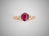 an oval ruby and diamond ring on a white background