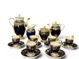 a group of blue and gold tea and coffee cups and saucers