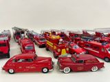 a lot of toy firetrucks that are lined up together