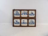 a picture of a blue and white tile in a wooden frame